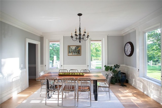 255 Camp Run Rd, Lancaster Twp, PA 16037 - dining room with a chandelier, plenty of natural light, light wood-style flooring, ornamental molding, and a wainscoted wall
