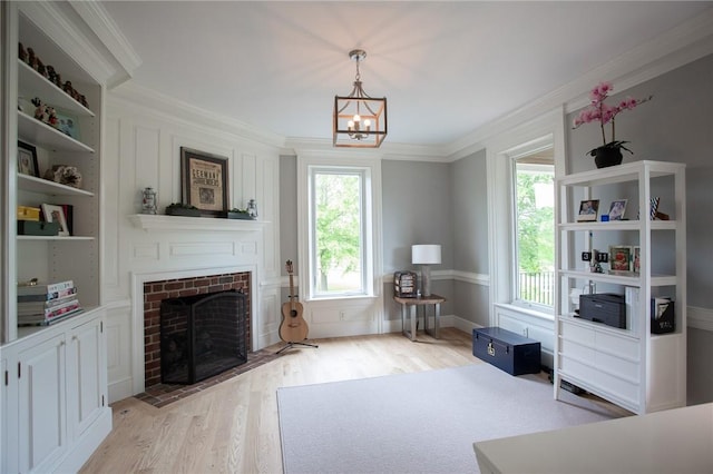 255 Camp Run Rd, Lancaster Twp, PA 16037 - living room with plenty of natural light, light wood finished floors, a brick fireplace, ornamental molding, and a chandelier