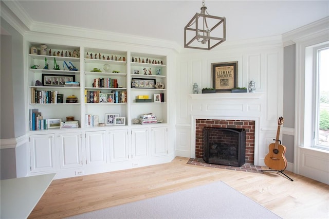 255 Camp Run Rd, Lancaster Twp, PA 16037 - living area featuring light wood finished floors, healthy amount of natural light, ornamental molding, a fireplace, and built in features