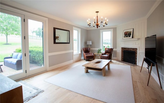 255 Camp Run Rd, Lancaster Twp, PA 16037 - living area featuring ornamental molding, a chandelier, light wood finished floors, and a brick fireplace