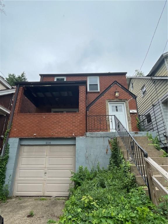 1114 Ingham St, Marshall Shadeland, PA 15212 - view of front facade featuring brick siding and an attached garage