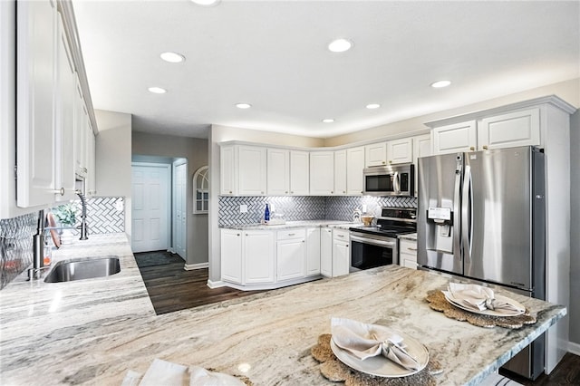 2310 Shamrock Ln, Canonsburg, PA 15317 - kitchen featuring stainless steel appliances, dark wood finished floors, white cabinetry, decorative backsplash, and light stone countertops