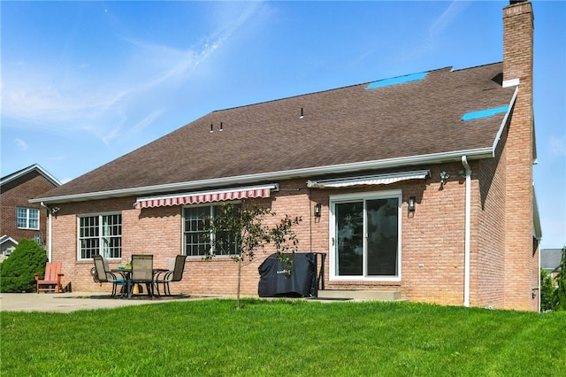 2310 Shamrock Ln, Canonsburg, PA 15317 - rear view of property featuring a chimney, brick siding, a patio, roof with shingles, and a yard