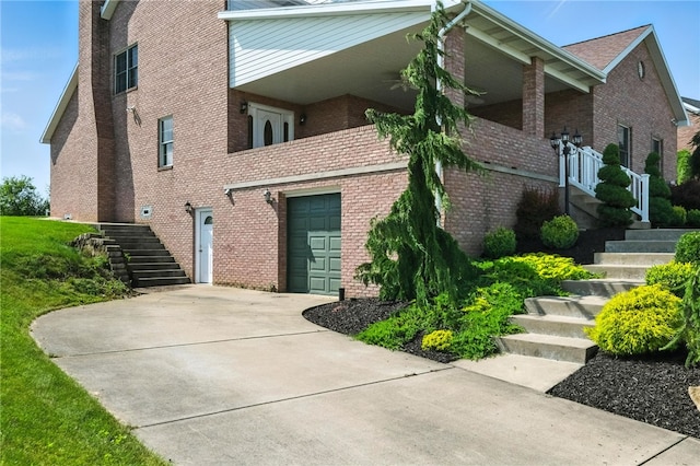 2310 Shamrock Ln, Canonsburg, PA 15317 - view of side of home featuring stairway, a garage, brick siding, and concrete driveway