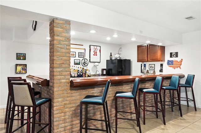 2310 Shamrock Ln, Canonsburg, PA 15317 - indoor bar with black fridge with ice dispenser, recessed lighting, and light tile patterned flooring