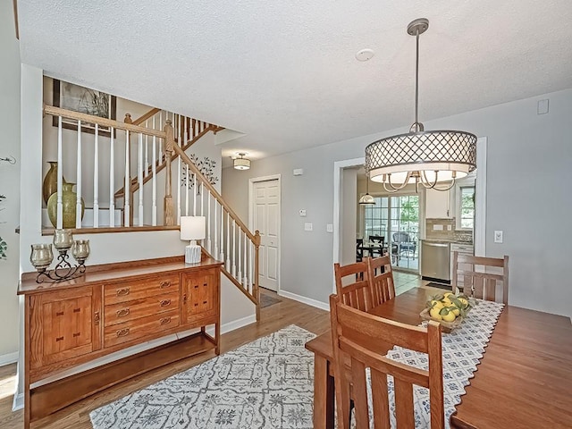 406 Country View Dr, Lower Burrell, PA 15068 - dining space featuring stairs, wood finished floors, and a textured ceiling