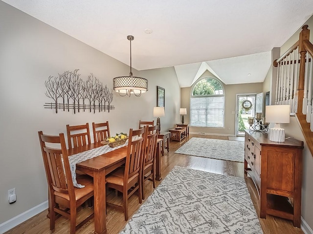 406 Country View Dr, Lower Burrell, PA 15068 - dining area featuring wood finished floors, vaulted ceiling, and stairs