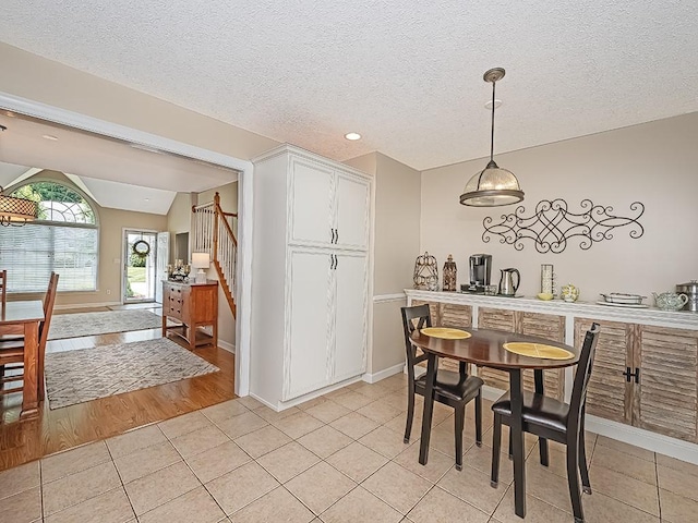 406 Country View Dr, Lower Burrell, PA 15068 - dining space featuring light tile patterned floors, stairs, a textured ceiling, lofted ceiling, and recessed lighting