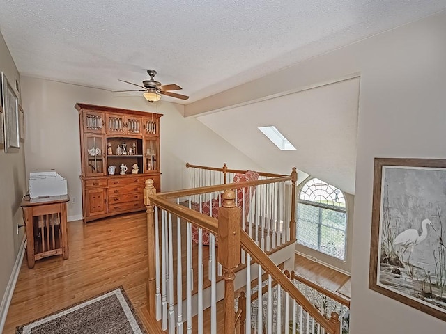 406 Country View Dr, Lower Burrell, PA 15068 - hall with light wood-style flooring, a textured ceiling, an upstairs landing, and a skylight