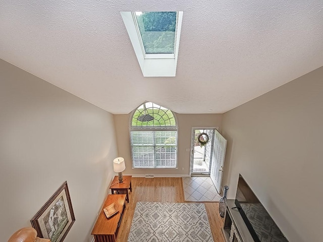 406 Country View Dr, Lower Burrell, PA 15068 - entrance foyer featuring wood finished floors, a textured ceiling, and a skylight