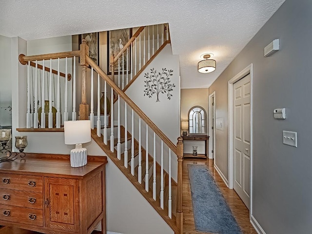 406 Country View Dr, Lower Burrell, PA 15068 - foyer featuring a textured ceiling, wood finished floors, and stairs