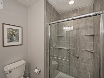 406 Country View Dr, Lower Burrell, PA 15068 - full bathroom with a textured ceiling and a stall shower