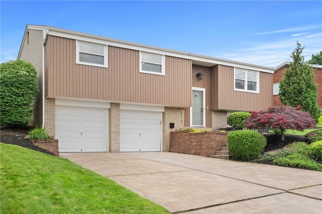 213 Thistle Dr, West Mifflin, PA 15122 - bi-level home with brick siding, concrete driveway, and a garage