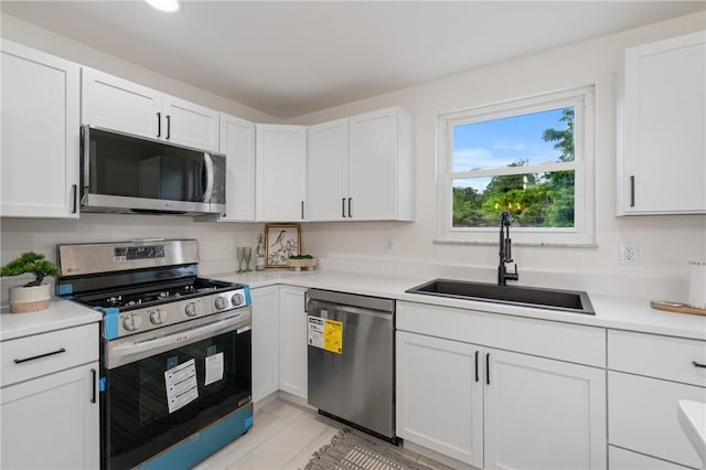 213 Thistle Dr, West Mifflin, PA 15122 - kitchen featuring stainless steel appliances, light countertops, and white cabinetry