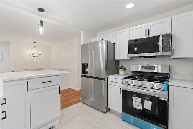 213 Thistle Dr, West Mifflin, PA 15122 - kitchen featuring stainless steel appliances, light countertops, decorative light fixtures, white cabinetry, and a chandelier