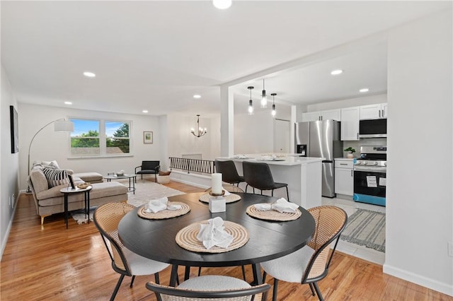 213 Thistle Dr, West Mifflin, PA 15122 - dining room featuring a chandelier, light wood finished floors, and recessed lighting