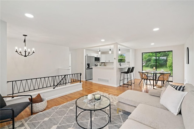 213 Thistle Dr, West Mifflin, PA 15122 - living area featuring light wood-style flooring, a chandelier, and recessed lighting