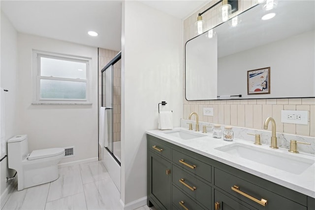 213 Thistle Dr, West Mifflin, PA 15122 - bathroom with double vanity, marble look tiles, combined bath / shower with glass door, and recessed lighting
