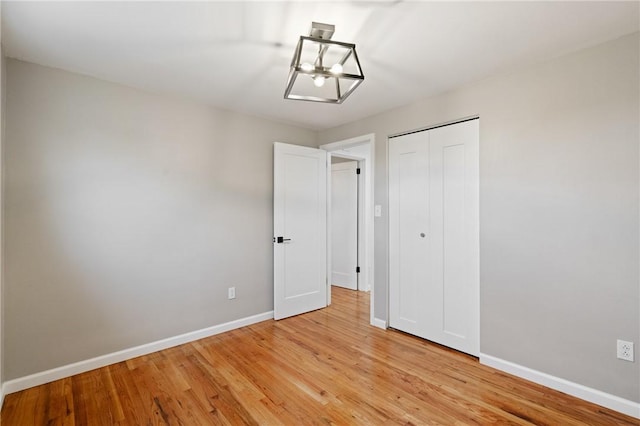 213 Thistle Dr, West Mifflin, PA 15122 - unfurnished bedroom featuring light wood finished floors, a chandelier, and a closet