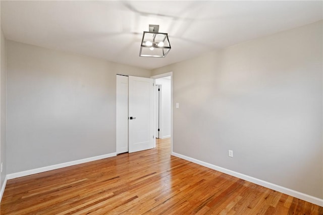 213 Thistle Dr, West Mifflin, PA 15122 - empty room featuring light wood finished floors and a chandelier