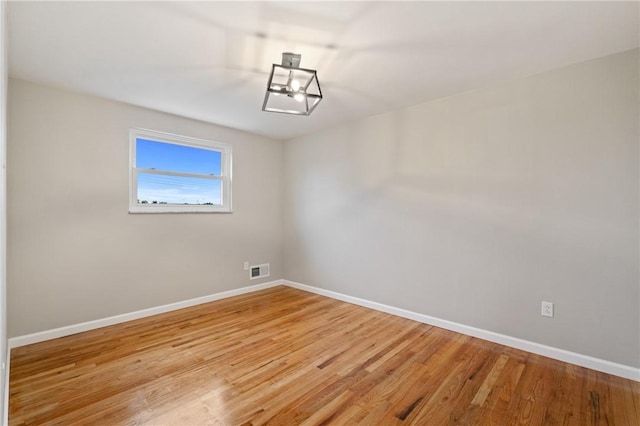 213 Thistle Dr, West Mifflin, PA 15122 - empty room featuring light wood finished floors and a chandelier