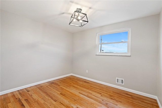 213 Thistle Dr, West Mifflin, PA 15122 - spare room with a chandelier and light wood-style flooring