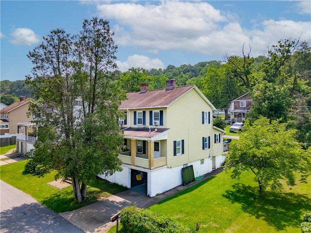 18 Allegheny Ave, South Fayette, PA 15031 - view of front of house with asphalt driveway, a front yard, an attached garage, and a chimney