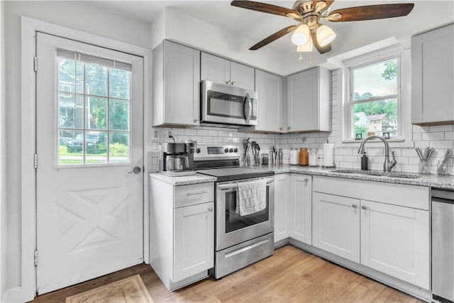 18 Allegheny Ave, South Fayette, PA 15031 - kitchen with appliances with stainless steel finishes, a ceiling fan, tasteful backsplash, and light stone counters