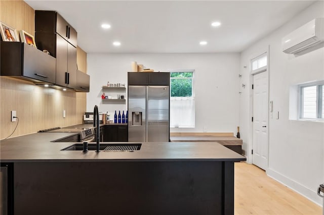 2013 Straubs Ln, Troy Hill, PA 15212 - kitchen with stainless steel fridge, a wall mounted AC, a peninsula, healthy amount of natural light, and recessed lighting