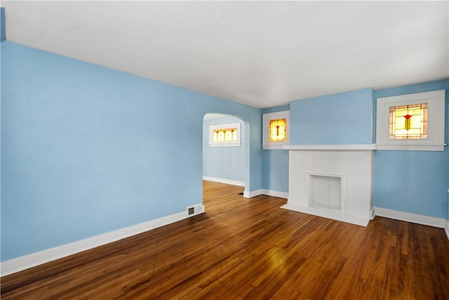 2301 Fairland St, Overbrook, PA 15210 - unfurnished living room with arched walkways and wood finished floors
