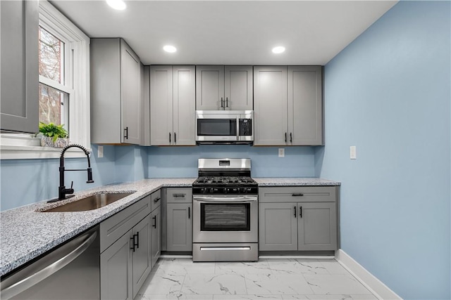2301 Fairland St, Overbrook, PA 15210 - kitchen with appliances with stainless steel finishes, gray cabinets, recessed lighting, light marble finish floors, and light stone countertops