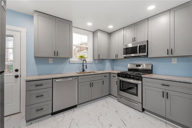 2301 Fairland St, Overbrook, PA 15210 - kitchen with stainless steel appliances, gray cabinets, light countertops, and recessed lighting