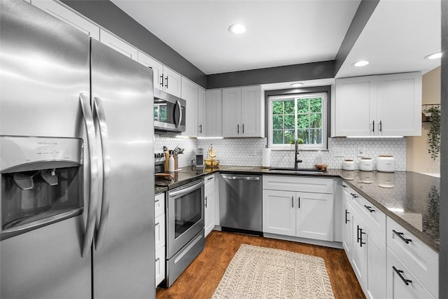401 Olde Ingomar Ct, Mccandless, PA 15237 - kitchen with stainless steel appliances, white cabinets, dark wood finished floors, decorative backsplash, and recessed lighting