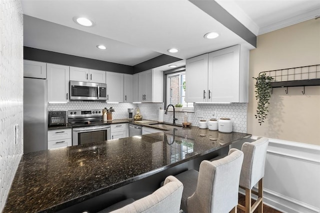 401 Olde Ingomar Ct, Mccandless, PA 15237 - kitchen featuring stainless steel appliances, dark stone counters, white cabinets, tasteful backsplash, and crown molding
