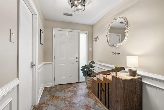401 Olde Ingomar Ct, Mccandless, PA 15237 - foyer featuring stone tile floors, a wainscoted wall, and a decorative wall