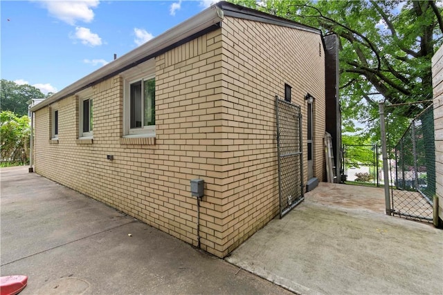 601 4th St, Penn Hills, PA 15147 - view of property exterior featuring a gate, brick siding, and a chimney