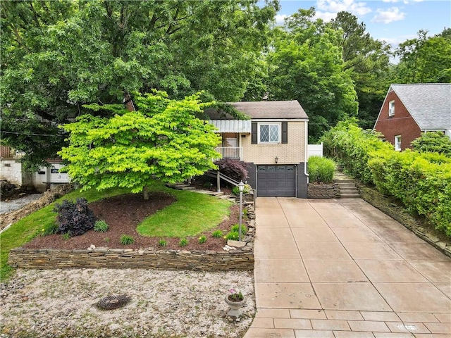 601 4th St, Penn Hills, PA 15147 - view of front of home featuring concrete driveway, an attached garage, stairway, and brick siding