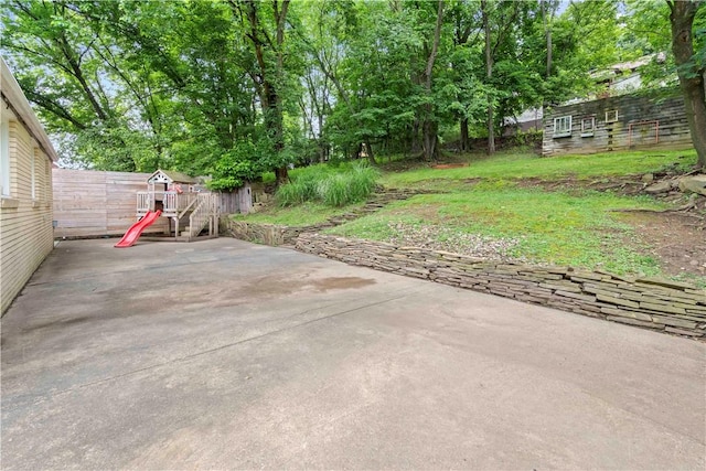 601 4th St, Penn Hills, PA 15147 - view of yard featuring a patio area, a playground, and view of wooded area