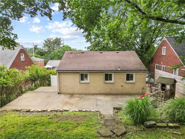 601 4th St, Penn Hills, PA 15147 - back of house featuring a patio area, brick siding, and a shingled roof