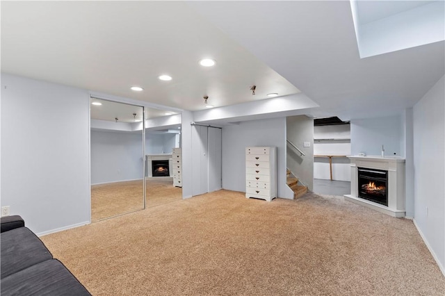 601 4th St, Penn Hills, PA 15147 - unfurnished living room with a lit fireplace, carpet flooring, recessed lighting, and stairway