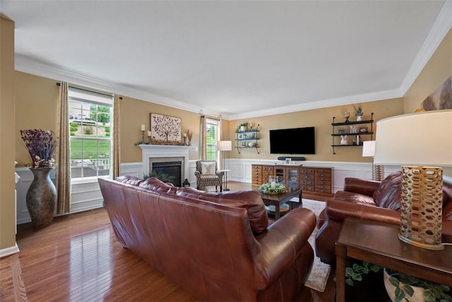743 Packsaddle Trl, Richland, PA 15044 - living area with ornamental molding, healthy amount of natural light, a glass covered fireplace, wood finished floors, and wainscoting