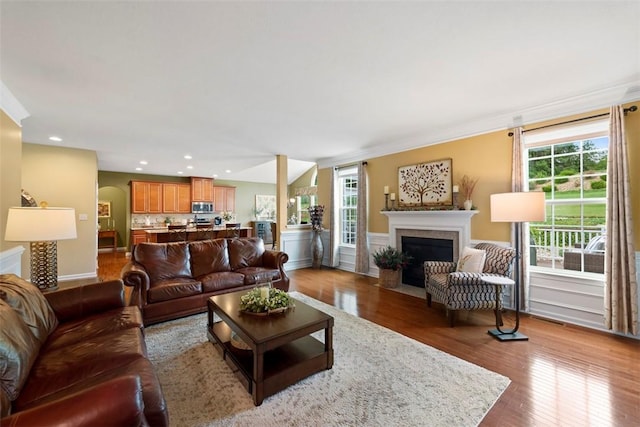 743 Packsaddle Trl, Richland, PA 15044 - living area featuring a fireplace with flush hearth, plenty of natural light, wood finished floors, recessed lighting, and arched walkways