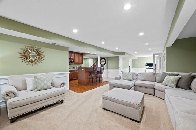 743 Packsaddle Trl, Richland, PA 15044 - living room with bar area, a decorative wall, wainscoting, recessed lighting, and light wood-style floors