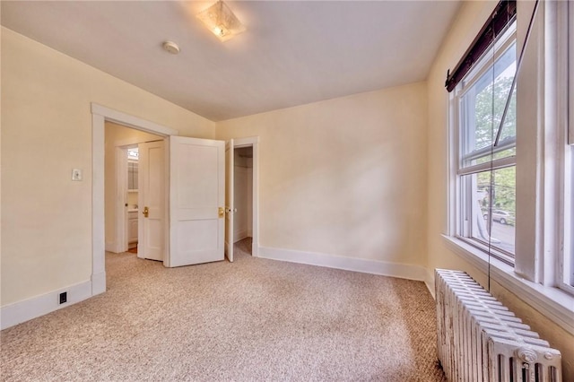 2267 Tilbury Ave, Squirrel Hill, PA 15217 - empty room with radiator heating unit, light carpet, and a smoke detector