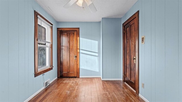 304 Wylie Ave, Elizabeth Twp/Boro, PA 15037 - unfurnished bedroom with wood-type flooring, a ceiling fan, and a decorative wall