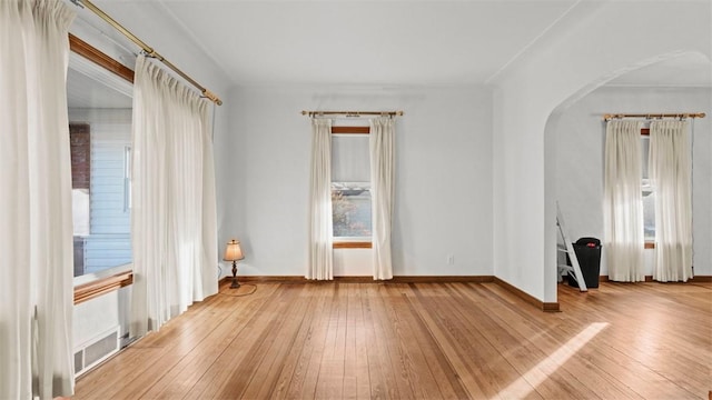 304 Wylie Ave, Elizabeth Twp/Boro, PA 15037 - empty room with arched walkways and hardwood / wood-style floors