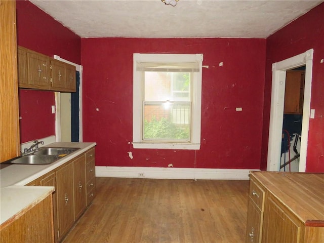 1465 Steuben St, Crafton Heights, PA 15205 - kitchen with light wood finished floors, brown cabinets, light countertops, and a textured ceiling