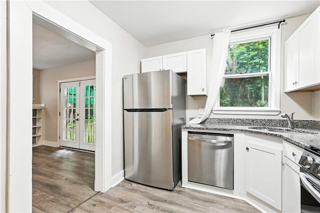 1334 Franklin Ave, Wilkinsburg, PA 15221 - kitchen featuring stainless steel appliances, stone counters, white cabinets, and healthy amount of natural light