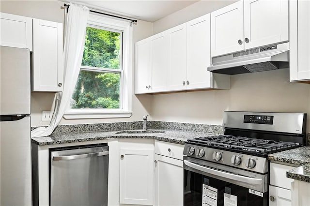 1334 Franklin Ave, Wilkinsburg, PA 15221 - kitchen with appliances with stainless steel finishes, under cabinet range hood, white cabinets, and dark stone counters
