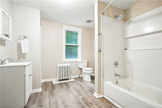1334 Franklin Ave, Wilkinsburg, PA 15221 - bathroom featuring radiator, vanity, wood finished floors, and shower / bathtub combination